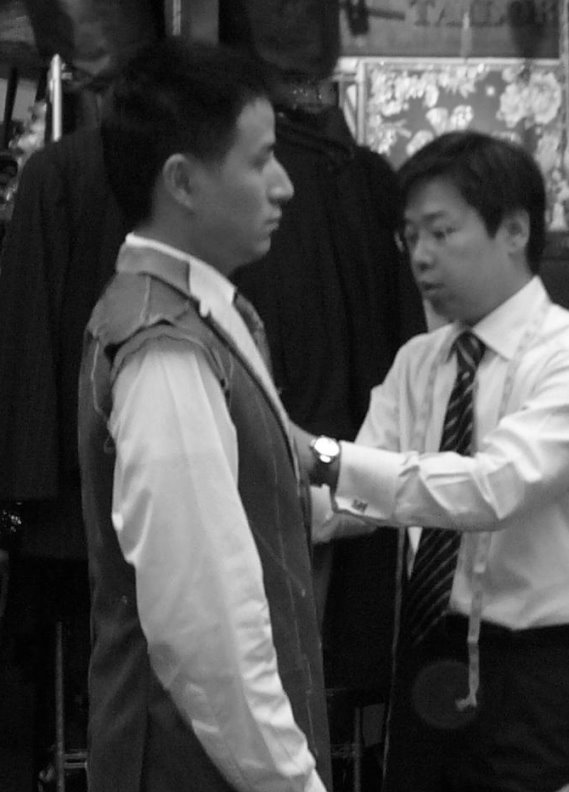 A tailor attending to a customer in Hong Kong
