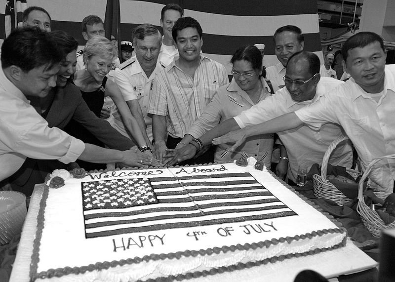 Vice Adm. Doug Crowder is joined by U.S. Ambassador to the Philippines, the Honorable Kristie A. Kenny and government officials from the Bicol region for a cake cutting during a 4th of July reception