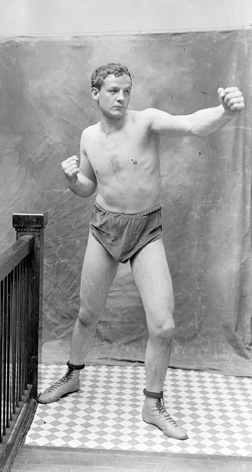 Pugilist, Marvin Hart, standing in a boxing stance, left fist out, right fist back